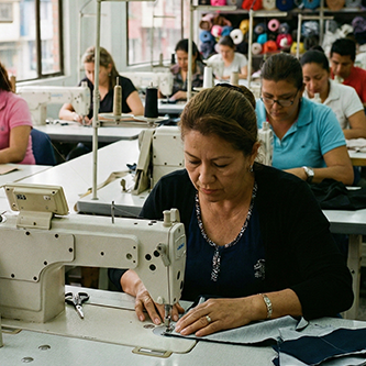 Seamstress working in a Colombian factory, illustrating nearshore apparel manufacture quality